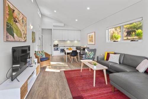 a living room with a couch and a tv at VILLA 17 CAPE VILLAS in Dunsborough