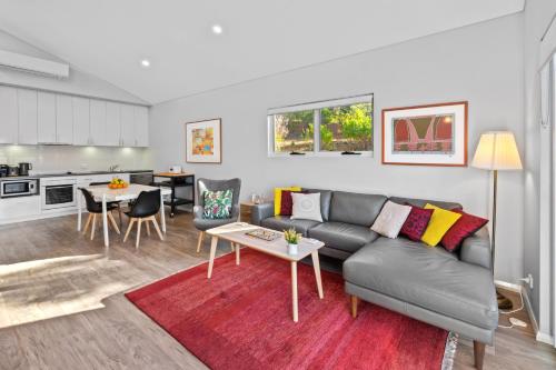 a living room with a couch and a table at VILLA 17 CAPE VILLAS in Dunsborough