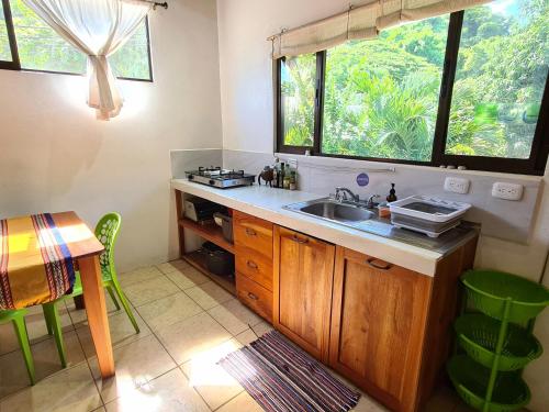 a kitchen with a sink and a table at Trebolmar Apartments for remote work in Santa Teresa Beach