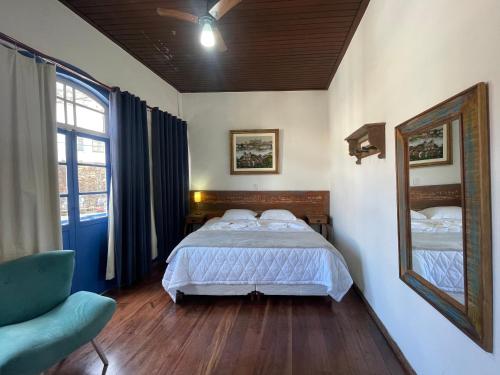 A bed or beds in a room at Caminhos da Liberdade Pousada