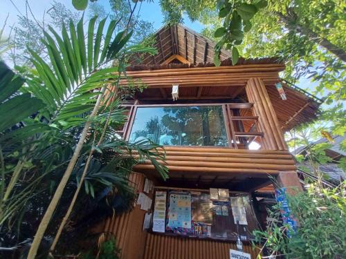 a tree house with a window on the side of it at Paras Inn Boracay in Boracay