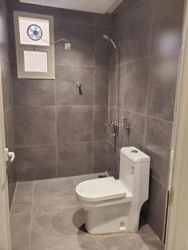 a bathroom with a toilet and a shower at فلل السيف الخاصة in Abha