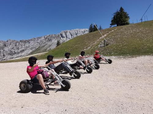 a group of people riding onicycles on a hill at STUDIO LES GLOVETTES in Villard-de-Lans