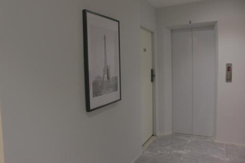 a picture hanging on a wall in a room at Nato house Ekkamai in Bangkok