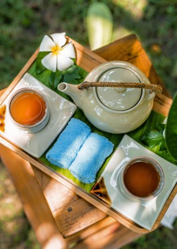 a tray with two cups of tea and a teapot at Furaveri Maldives - COMPLIMENTARY ROUND-TRIP SEAPLANE TRANSFER for two for a minimum of 5 nights or more from May 1st to October 31st, 2025 in Raa Atoll