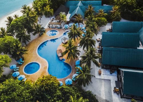 an aerial view of a resort swimming pool with palm trees at Furaveri Maldives - COMPLIMENTARY ROUND-TRIP SEAPLANE TRANSFER for two for a minimum of 5 nights or more from May 1st to October 31st, 2025 in Raa Atoll