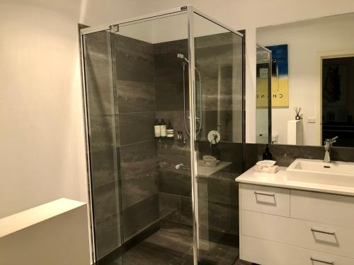 a bathroom with a glass shower and a sink at a'meadow in Trentham