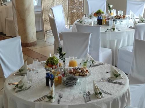 a white table with plates of food on it at Hotel MAGNAT in Głogów Małopolski