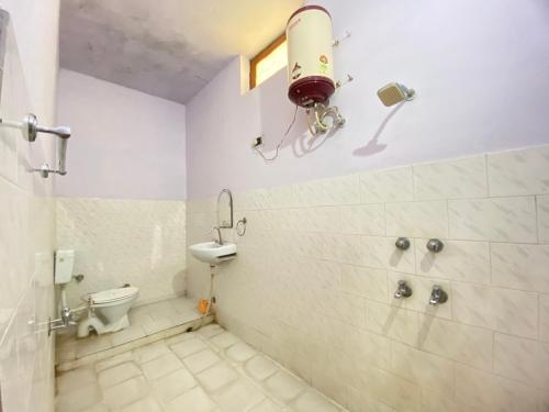 a bathroom with a shower and a toilet in it at Hotel Shri Mahant Orchha 5 mint Walking from Ram Raja Temple in Orchha