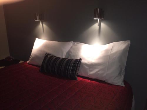 a bedroom with a bed with two pillows at Benalla Apartments in Benalla