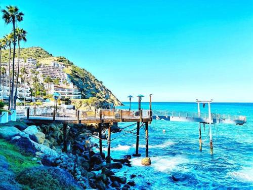 a pier in the ocean with a beach at Modern Hamilton Cove Villa w/golf cart in Avalon