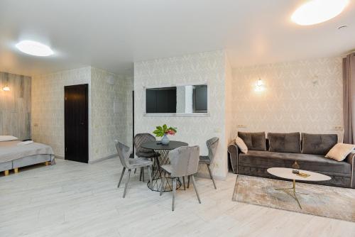 a living room with a couch and a table at Bastiono apartamentai in Klaipėda