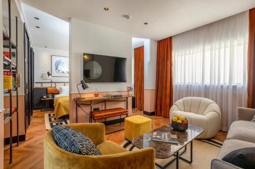 a living room with a couch and a table at Backstage Hotel - an Atlas Boutique Hotel in Tel Aviv