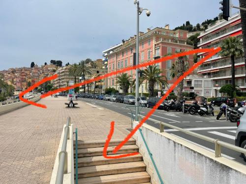 a street with orange ribbons on the side of a road at La Room: seaside apartment + terrace + parking in Menton