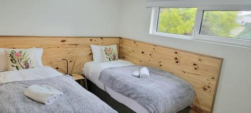 a bedroom with two beds and two windows at Merry Mary in Marysville