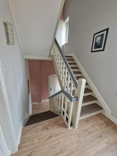a stairwell with a white staircase with a stair case at Stylisches Apartment in Hohenlimburg in Hagen