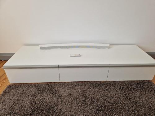a white bed sitting on top of a rug at Stylisches Apartment in Hohenlimburg in Hagen