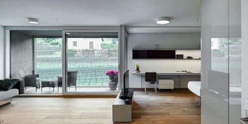 a living room with a kitchen and a dining room at Lo Scudo di Stabio in Stabio