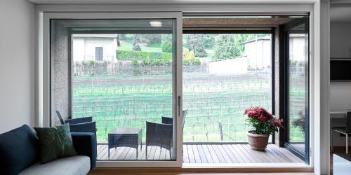 a living room with a sliding glass door to a patio at Lo Scudo di Stabio in Stabio
