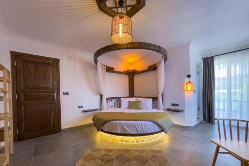 a bedroom with a bed with a lighted headboard at Limon Apart in Akyaka