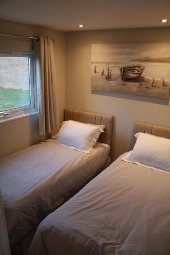 Säng eller sängar i ett rum på LA BELLA CHALETS 1 - 154 Sunbeach Holiday Village Scratby
