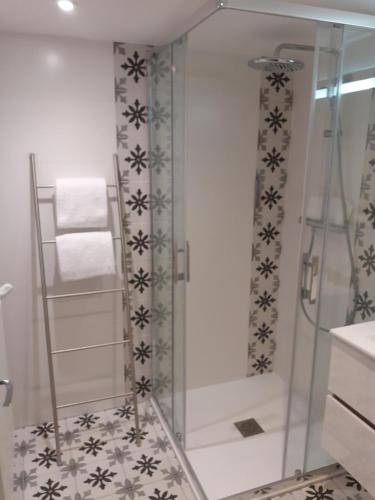 a shower with a glass door in a bathroom at Hotel de Charme La Bonne Adresse - Logis hotels in Le Havre