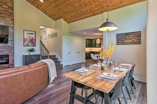 a dining room with a table and a couch at Breathtaking Views Unique Chimney Rock Cottage! in Lake Lure
