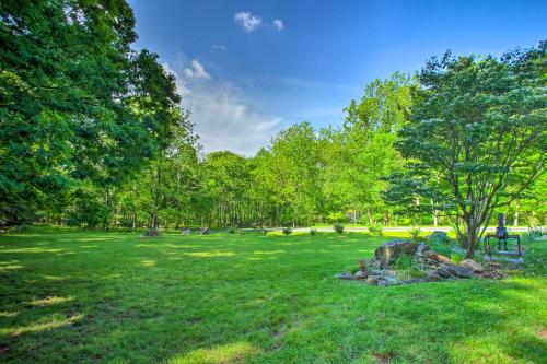 a park with a tree and rocks in the grass at Renovated Studio on 5 Acres - Near Vineyards! in Crozet