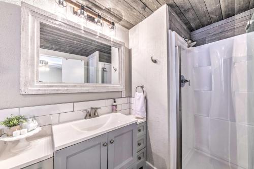 a bathroom with a sink and a shower and a mirror at Quiet Cloudcroft Cabin with Porch and Gas Grill! in Cloudcroft