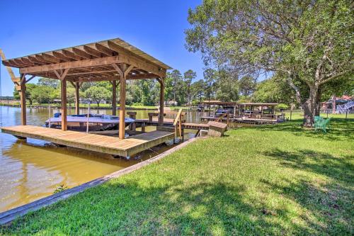 a wooden gazebo on the water in a park at Waterfront Onalaska Retreat with Private Dock! in Blanchard