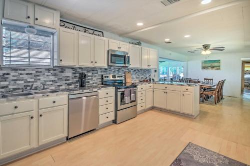 a large kitchen with white cabinets and a dining room at Waterfront Onalaska Retreat with Private Dock! in Blanchard