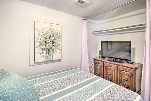 a bedroom with a bed and a flat screen tv at Waterfront Onalaska Retreat with Private Dock! in Blanchard