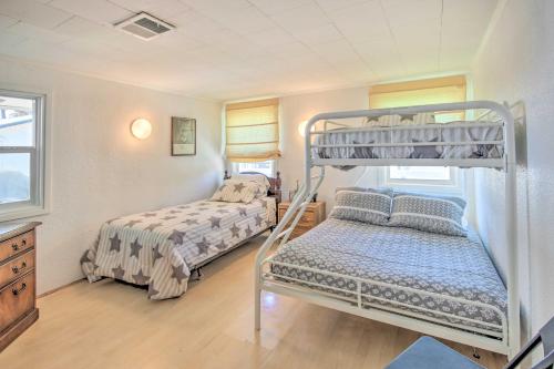 a bedroom with two beds and a bunk bed at Waterfront Onalaska Retreat with Private Dock! in Blanchard