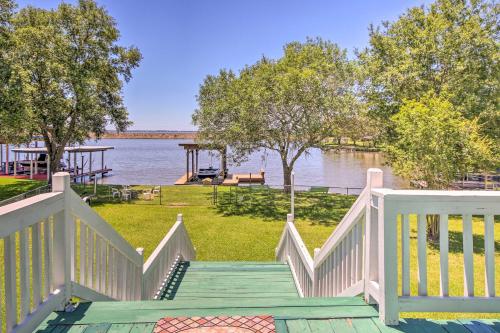 a staircase leading down to a river with a view of the water at Waterfront Onalaska Retreat with Private Dock! in Blanchard