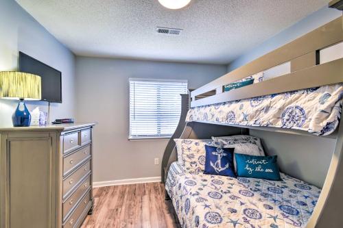 a bedroom with a bunk bed and a dresser at Little River Condo with Pool about 3 Mi to Beach! in Little River