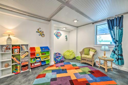 a childs room with a colorful rug and a chair at Northern Nights Beachfront Cottage in Kalkaska in Kalkaska