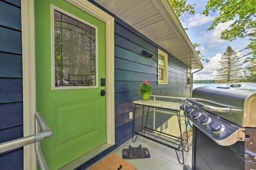 a front door of a house with a green door at Northern Nights Beachfront Cottage in Kalkaska in Kalkaska