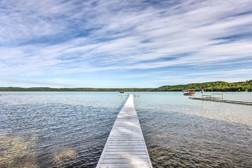 a dock stretches out into the water on a lake at Waterfront Glenn Lake Condo Gas Grill and Views in Glen Arbor