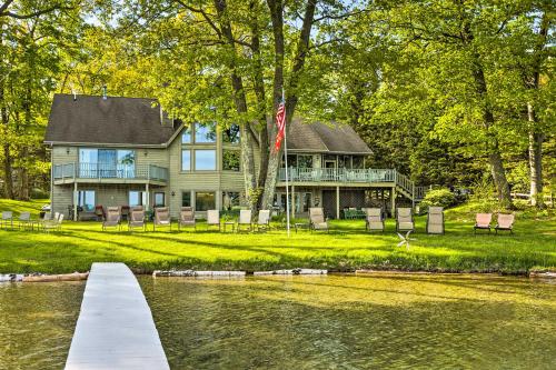 a large house with a bridge over a body of water at Waterfront Glenn Lake Condo Gas Grill and Views in Glen Arbor