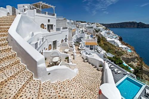 a view of the ocean from the side of a white building at Filotera Suites in Oia