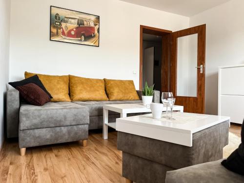 a living room with a couch and a table at Uroczy Apartament Pod Skarpą in Wadowice