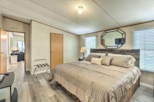 a bedroom with a large bed and a mirror at Charming Countryside Home with Covered Porch! in Livingston