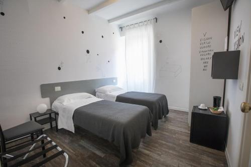 Una cama o camas en una habitación de Boutique Hotel Novecento