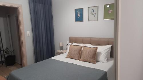 a bedroom with a large bed with two pillows at Apt22 stylish apartment close of Heraklion center in Heraklio Town