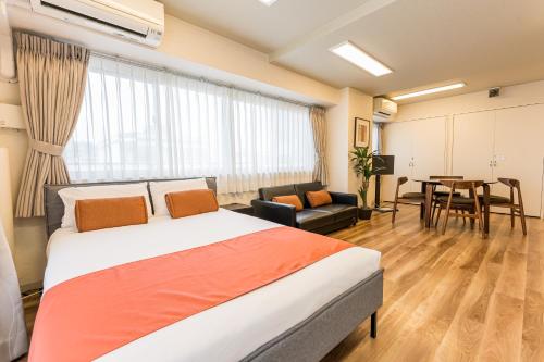 a bedroom with a large bed and a dining room at Oshiage Sky View Terrace Penthouse - brand new Hot Tab installed July 2025- in Tokyo