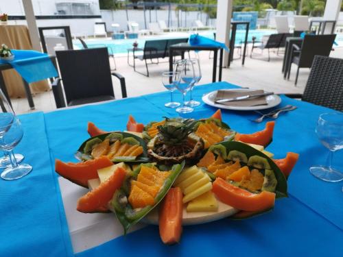 a plate of fruit on a blue table at HOTEL CRISTALLO PAESTUM in Capaccio-Paestum