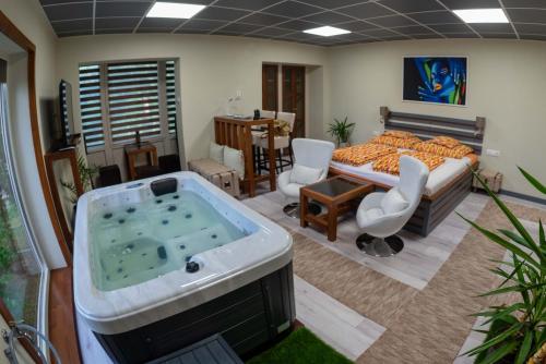 a bedroom with a tub in the middle of a room at E 14 in Berekfürdő