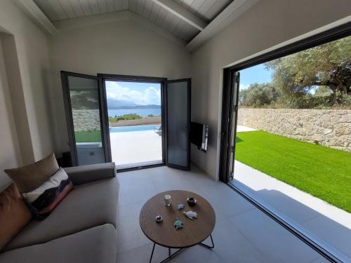 a living room with a couch and a table at Alekos Beach Houses-Elia Villas in Lixouri
