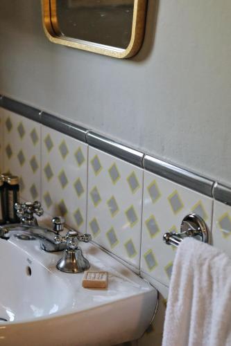 a bathroom with a white sink and a mirror at Borgo Valle Rita in Ginosa Marina