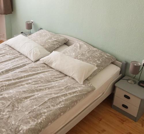 a bed with two pillows on top of it at Ferienwohnungen Schenk Schmitz in Bad Bertrich